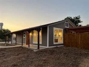 view of back house at dusk