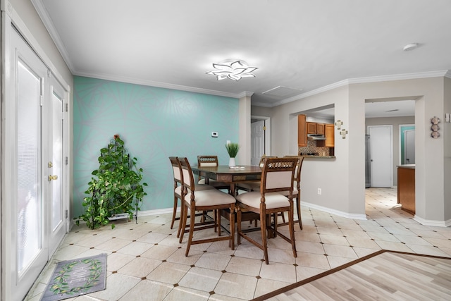 dining space featuring ornamental molding, light hardwood / wood-style flooring, and plenty of natural light