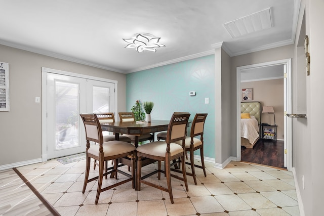 dining area with ornamental molding and french doors