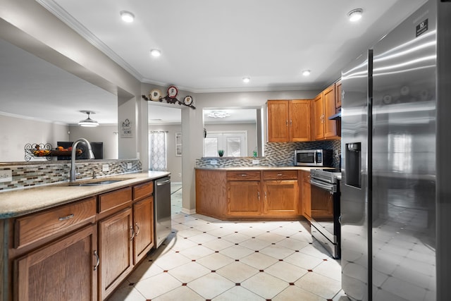 kitchen featuring stainless steel appliances, crown molding, and backsplash