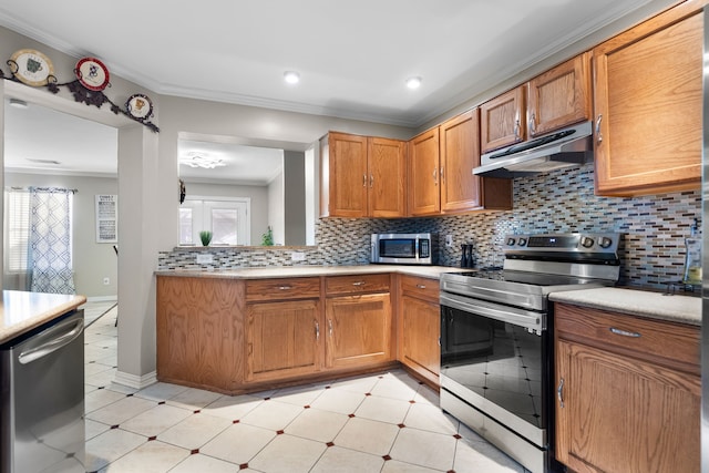 kitchen with tasteful backsplash, ornamental molding, stainless steel appliances, and a healthy amount of sunlight