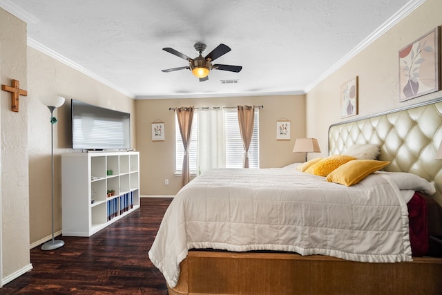 bedroom with ceiling fan, dark wood-type flooring, ornamental molding, and a textured ceiling