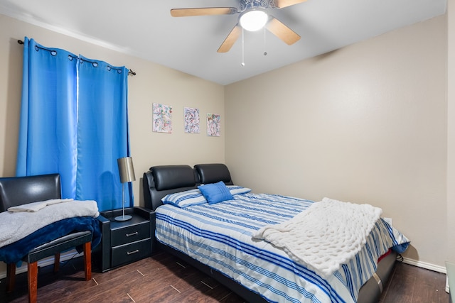 bedroom with dark hardwood / wood-style floors and ceiling fan