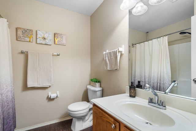 bathroom featuring vanity, hardwood / wood-style floors, and toilet