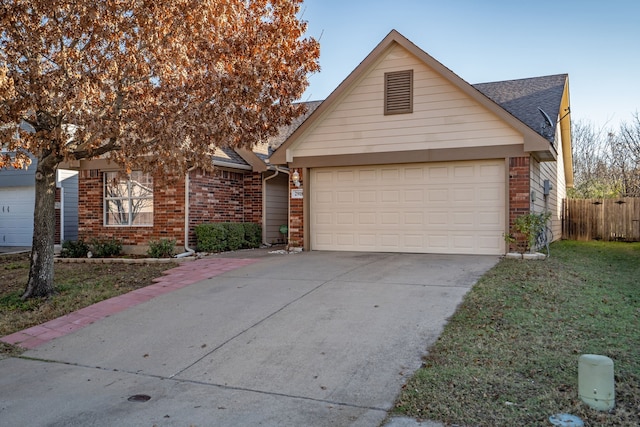 view of front of house with a front yard and a garage