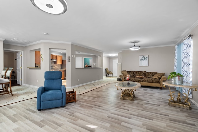 living room with ornamental molding and light wood-type flooring