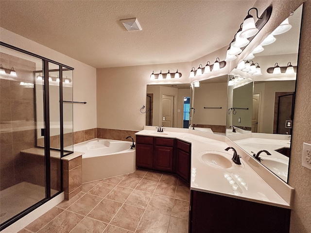 bathroom featuring vanity, shower with separate bathtub, and a textured ceiling