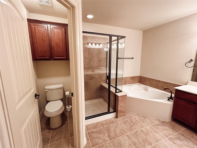 full bathroom featuring tile patterned floors, toilet, a textured ceiling, vanity, and plus walk in shower