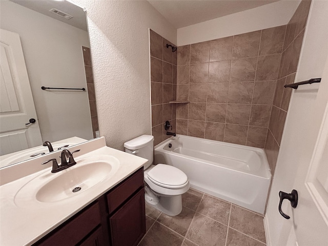 full bathroom with tile patterned floors, vanity, toilet, and tiled shower / bath combo