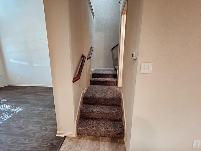 stairway with hardwood / wood-style floors