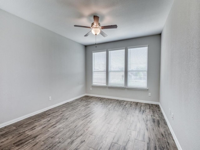 unfurnished room featuring hardwood / wood-style flooring and ceiling fan