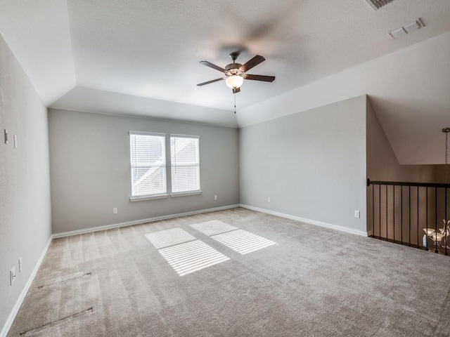 carpeted spare room with ceiling fan and lofted ceiling