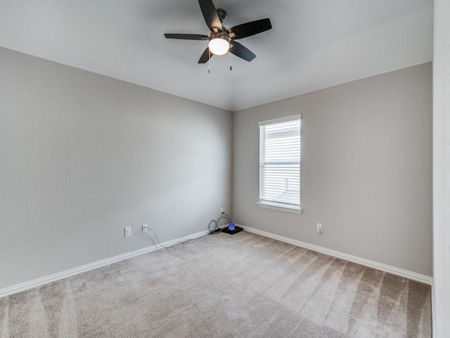 unfurnished room featuring ceiling fan and carpet floors