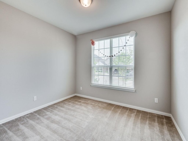 unfurnished room with light colored carpet