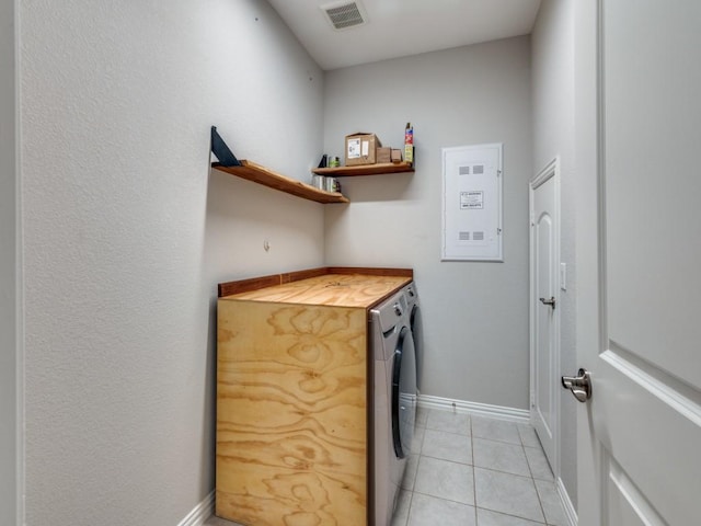 clothes washing area featuring independent washer and dryer and light tile patterned floors