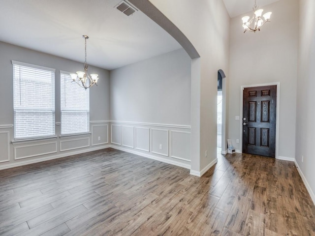 foyer with hardwood / wood-style flooring and a notable chandelier