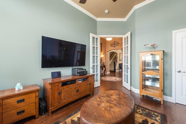 living room with ornamental molding, ceiling fan, dark hardwood / wood-style flooring, and french doors