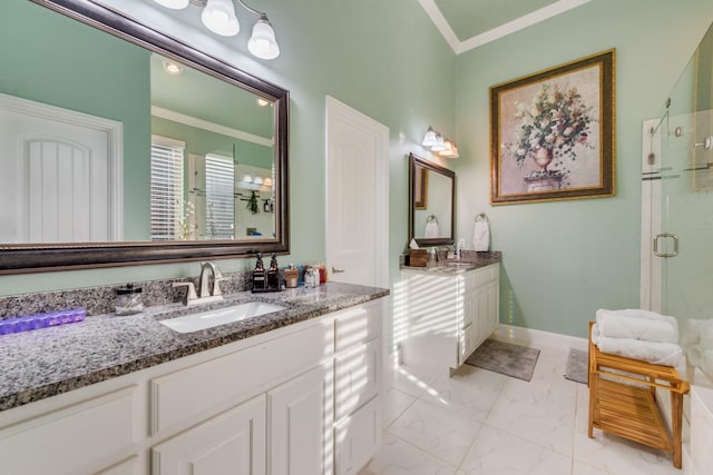 bathroom with ornamental molding, vanity, and walk in shower