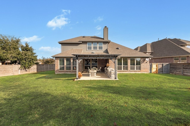 back of house with a patio and a yard