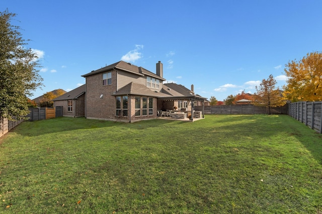 rear view of property featuring a yard and a patio