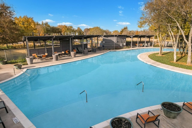 view of swimming pool featuring an outdoor fire pit and a patio