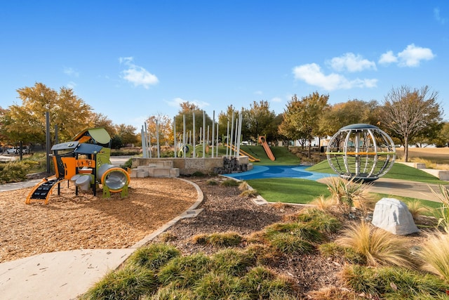 view of playground with a lawn