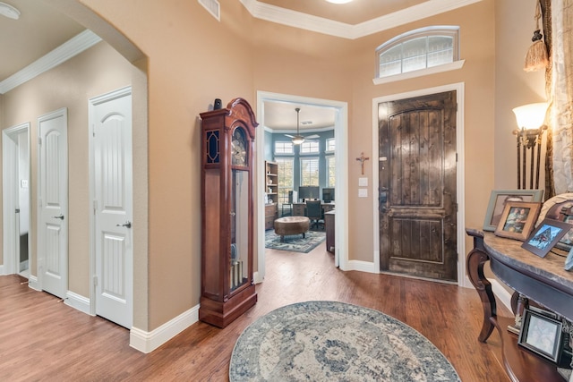 entrance foyer with ornamental molding and wood-type flooring