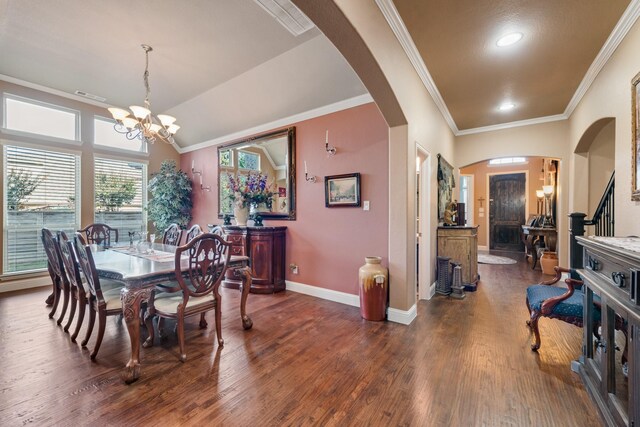 dining room with ornamental molding, vaulted ceiling, dark wood-type flooring, and a chandelier