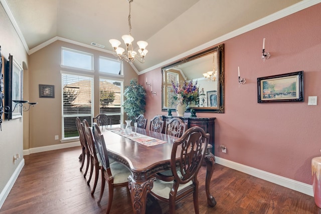 dining space featuring lofted ceiling, hardwood / wood-style floors, crown molding, and a chandelier