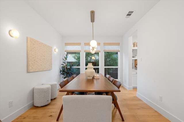 dining space with light hardwood / wood-style flooring