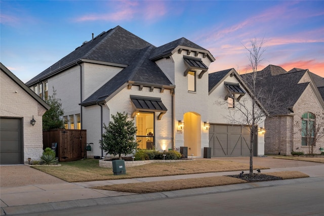 french country style house featuring a garage