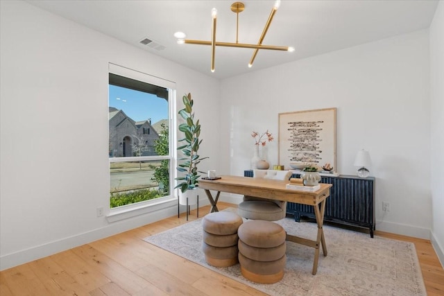 office area featuring wood-type flooring and a notable chandelier