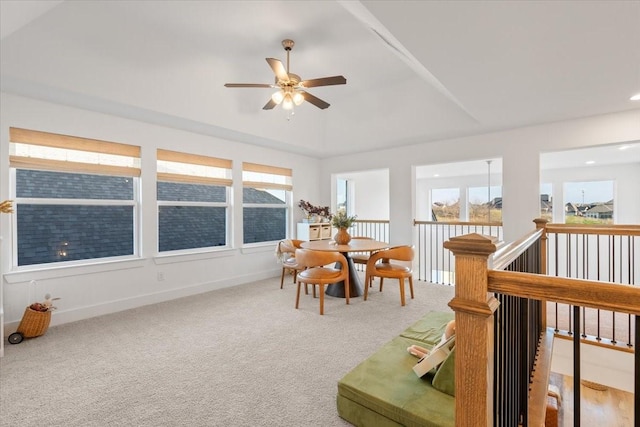 sunroom with ceiling fan and a raised ceiling