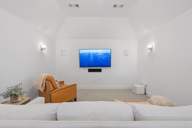 carpeted cinema room with lofted ceiling