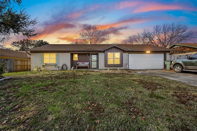 single story home featuring a yard and a garage