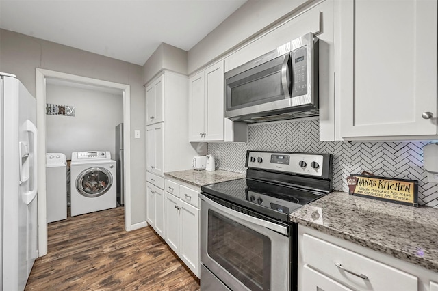 kitchen featuring white cabinetry, light stone countertops, independent washer and dryer, and stainless steel appliances