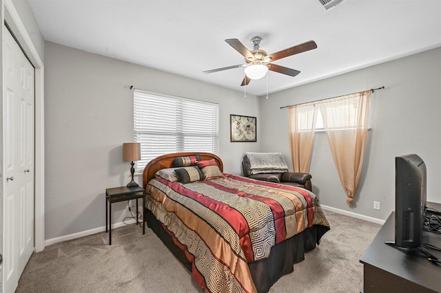 carpeted bedroom featuring a closet and ceiling fan