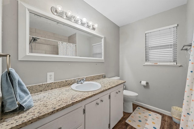 bathroom featuring a shower with curtain, hardwood / wood-style floors, vanity, and toilet