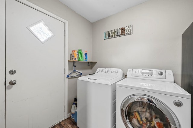 clothes washing area with independent washer and dryer and dark hardwood / wood-style flooring