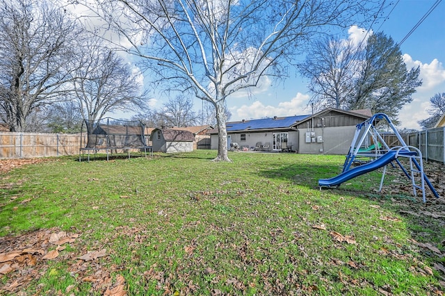 view of yard featuring a playground and a trampoline