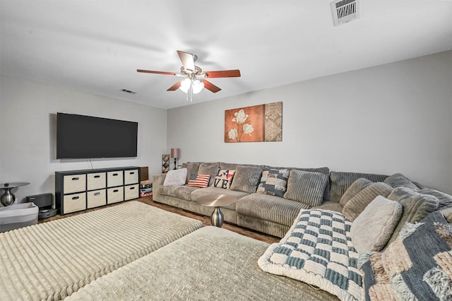 living room featuring hardwood / wood-style floors and ceiling fan