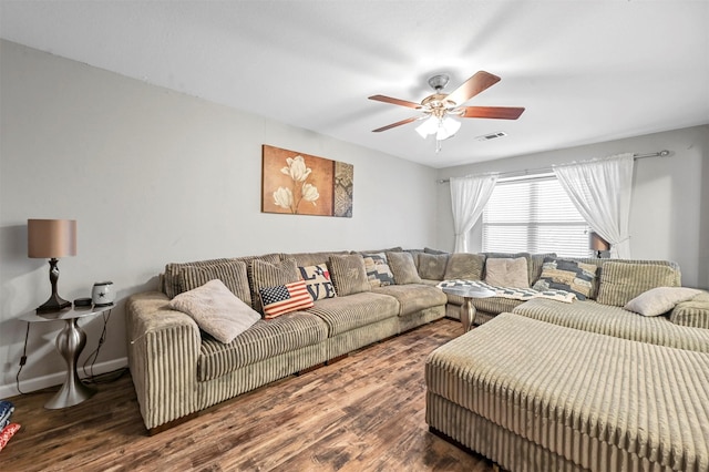 living room with ceiling fan and dark hardwood / wood-style flooring