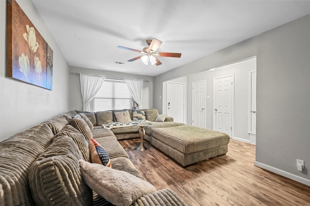 living room featuring hardwood / wood-style flooring and ceiling fan