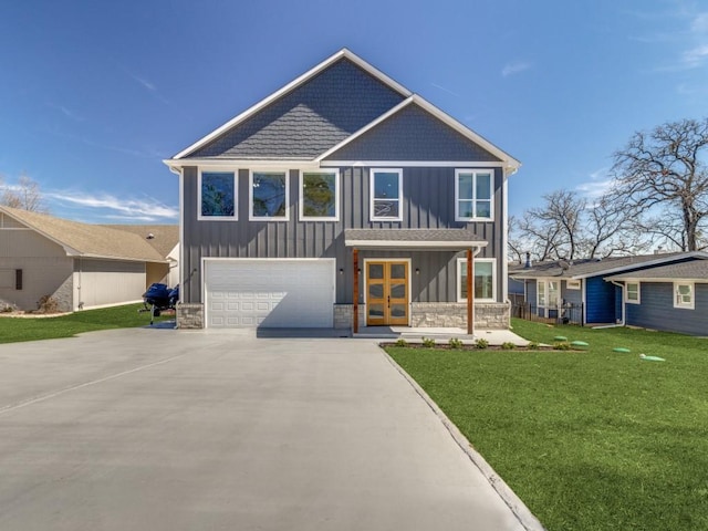 view of front facade with a garage and a front lawn