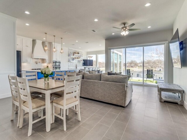 tiled dining room with ceiling fan