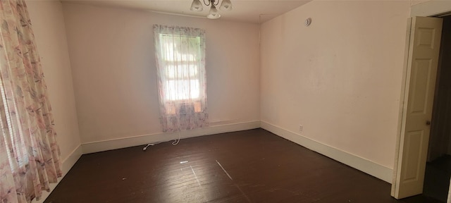 spare room featuring dark wood-type flooring