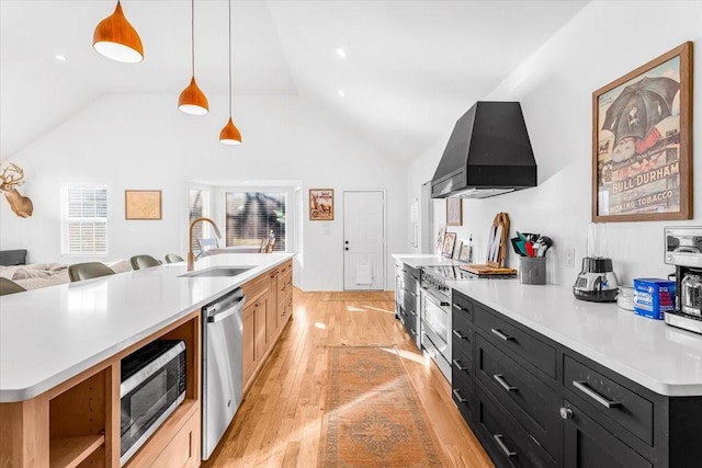 kitchen with appliances with stainless steel finishes, decorative light fixtures, custom exhaust hood, and a center island with sink