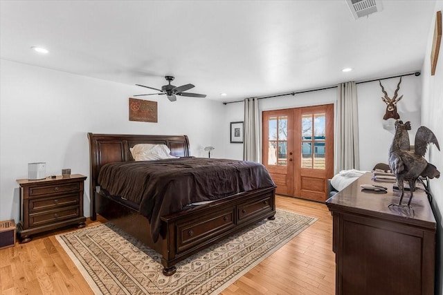 bedroom with ceiling fan, access to exterior, light wood-type flooring, and french doors