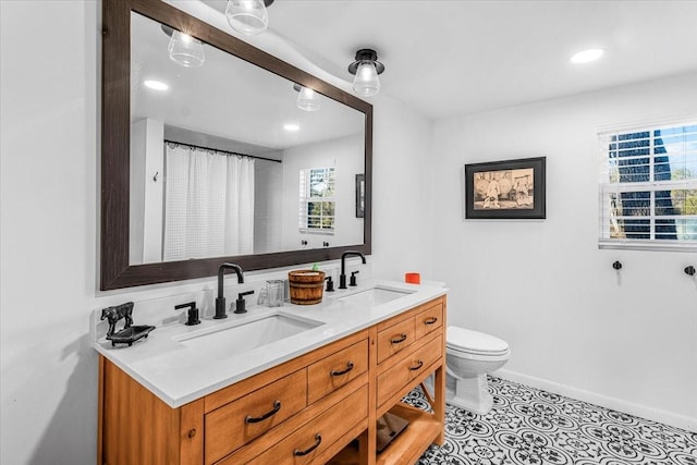 bathroom featuring vanity, toilet, and tile patterned flooring