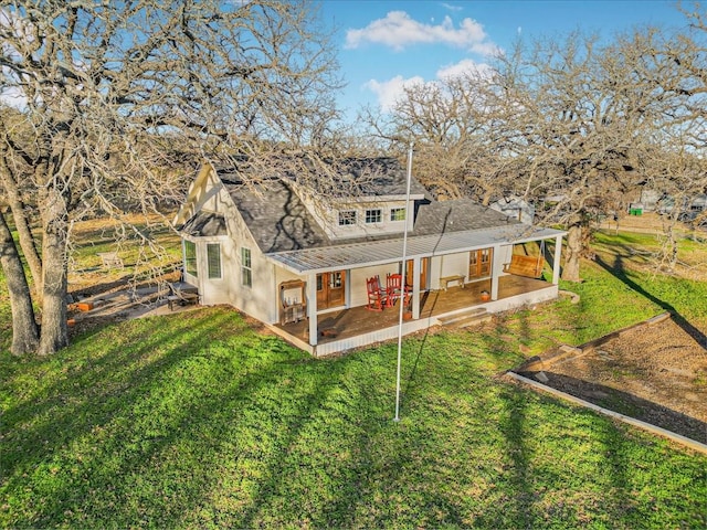 back of property with a yard and a patio